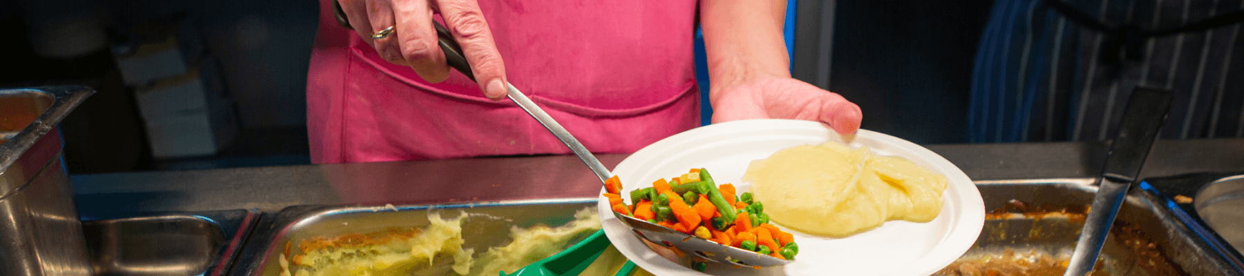 hands serving food - solve homelessness