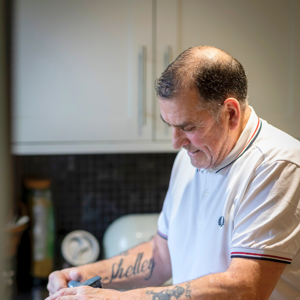 Man at home washing dishes