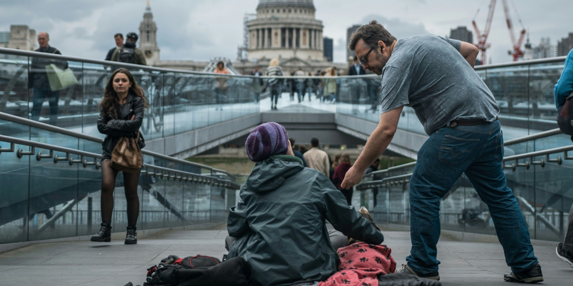 man giving to person rough sleeping